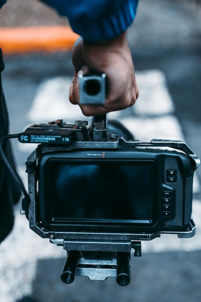 pexels-photo-3101496-3101496 Close-up view of a professional camera rig handheld during a film production.